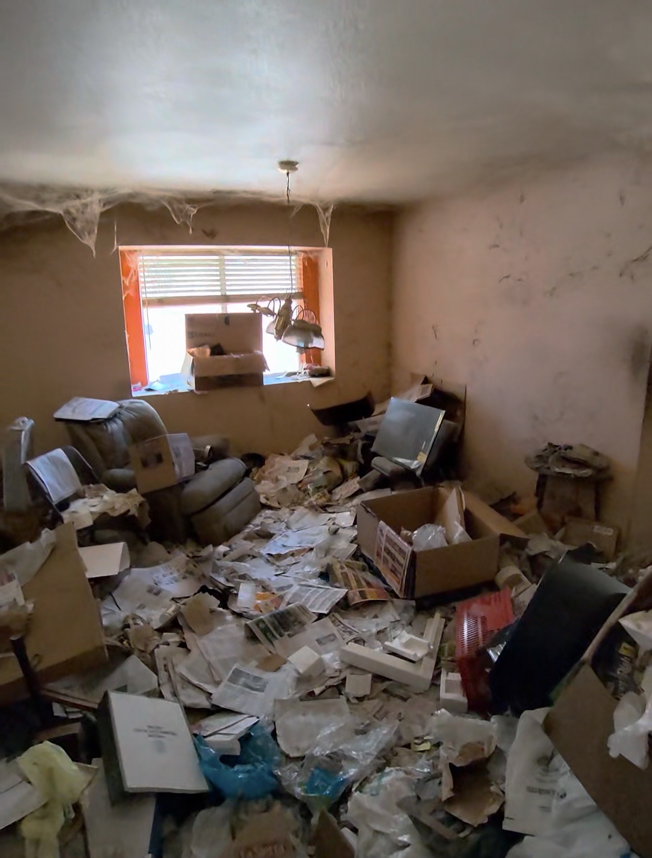 Room filled with clutter before cleanout