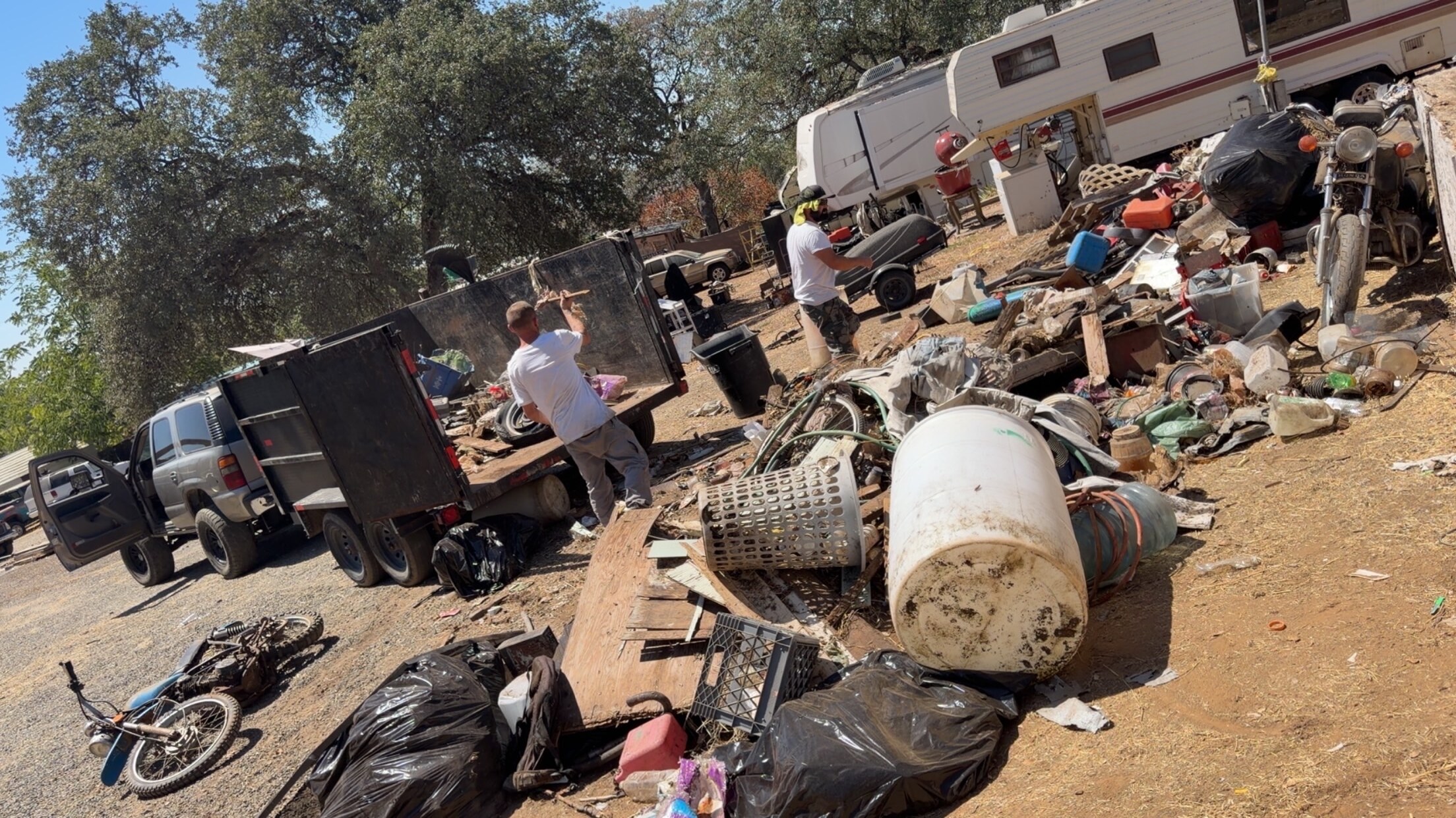 Outdoor property filled with debris before Grinder Junk Removal cleanup
